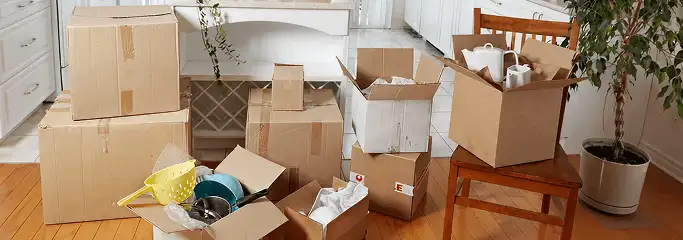 Packed moving boxes and household items in a kitchen before move-out or move-in cleaning, Las Vegas, NV.
